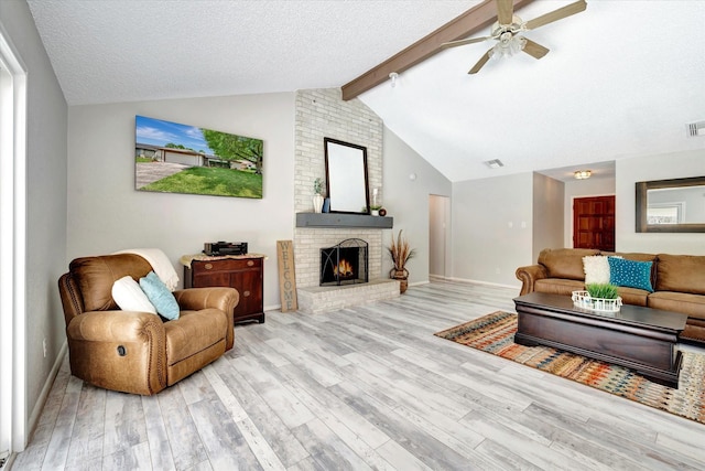 15707 Spring Forest Dr, Houston, TX 77059 - living room with wood finished floors, ceiling fan, a fireplace, and a textured ceiling