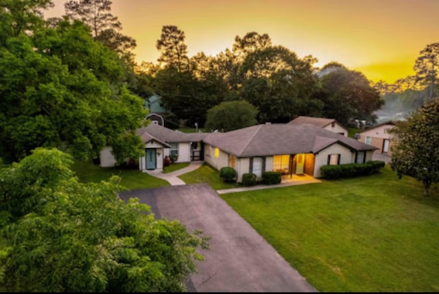 32047 S Wiggins St, Magnolia, TX 77355 - ranch-style house featuring a front lawn and driveway