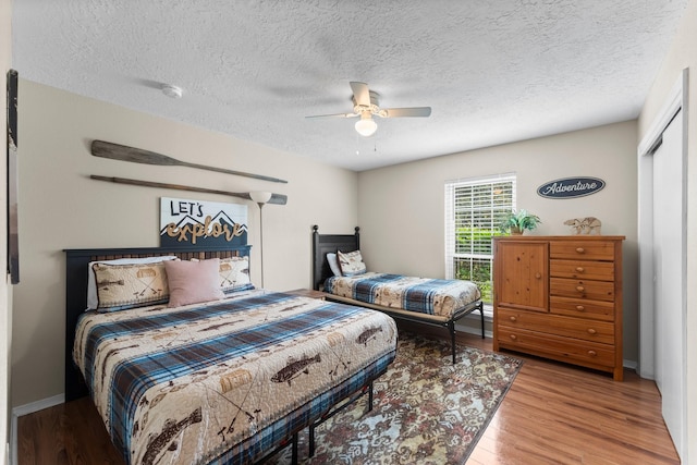 32047 S Wiggins St, Magnolia, TX 77355 - bedroom with wood finished floors, a textured ceiling, and ceiling fan