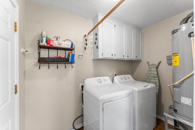 32047 S Wiggins St, Magnolia, TX 77355 - laundry area with water heater, cabinet space, washer and clothes dryer, and a textured ceiling