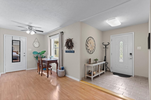 32047 S Wiggins St, Magnolia, TX 77355 - entryway with a ceiling fan, light wood finished floors, and a textured ceiling