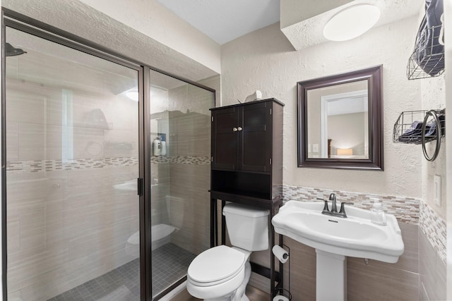 32047 S Wiggins St, Magnolia, TX 77355 - full bathroom with a textured wall and a shower stall