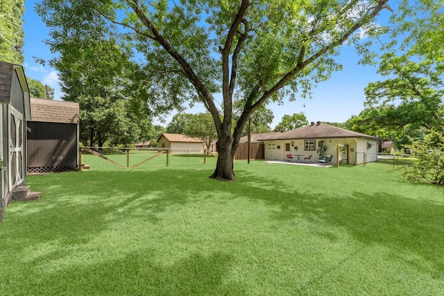 32047 S Wiggins St, Magnolia, TX 77355 - fenced backyard featuring a storage unit and a patio area