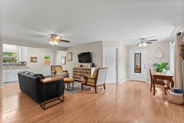 32047 S Wiggins St, Magnolia, TX 77355 - living room featuring a ceiling fan and light wood finished floors