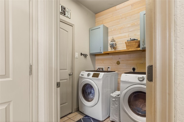 18715 Deer Trace Dr, Crosby, TX 77532 - laundry room with cabinet space, wooden walls, washing machine and clothes dryer, and light tile patterned floors
