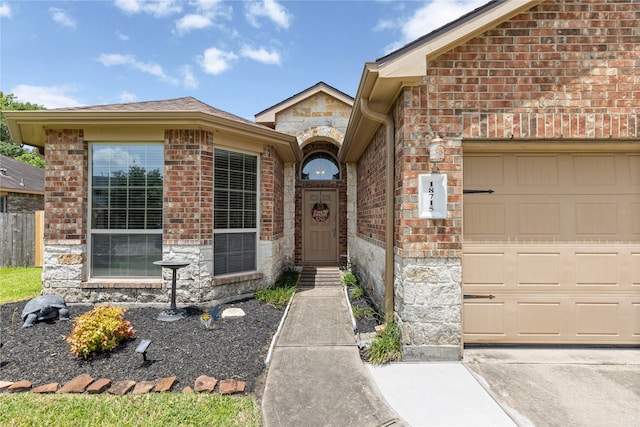 18715 Deer Trace Dr, Crosby, TX 77532 - doorway to property with stone siding, a garage, and brick siding