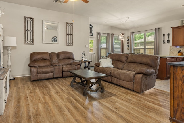 18715 Deer Trace Dr, Crosby, TX 77532 - living area featuring light wood finished floors and ceiling fan