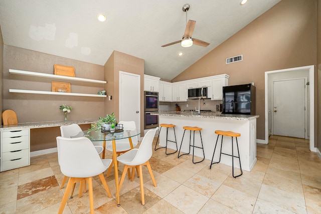 6115 Downwood Forest Dr, Houston, TX 77088 - dining room with a ceiling fan, high vaulted ceiling, recessed lighting, and light tile patterned flooring