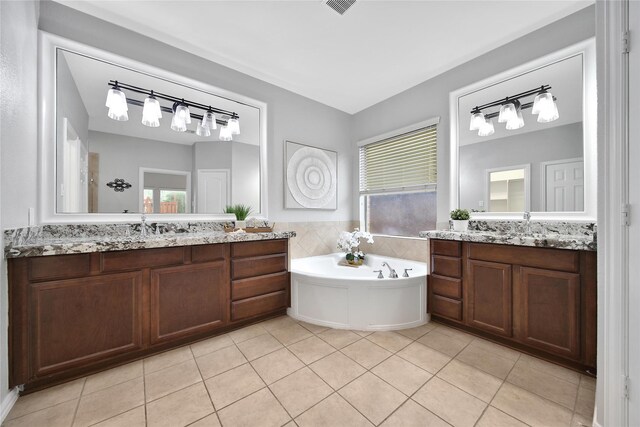 14314 Prosper Ridge Dr, Cypress, TX 77429 - full bathroom featuring two vanities, tile patterned floors, and a bath