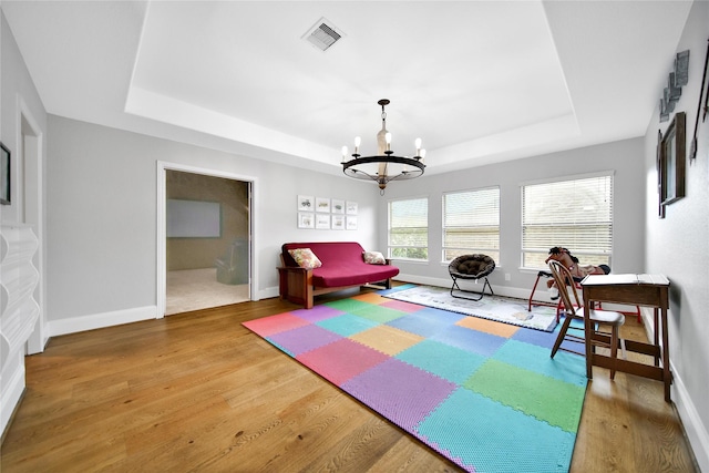 14314 Prosper Ridge Dr, Cypress, TX 77429 - game room featuring a tray ceiling, a chandelier, and wood finished floors