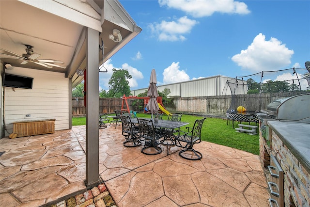 14314 Prosper Ridge Dr, Cypress, TX 77429 - fenced backyard featuring outdoor dining space, ceiling fan, a patio area, and exterior kitchen