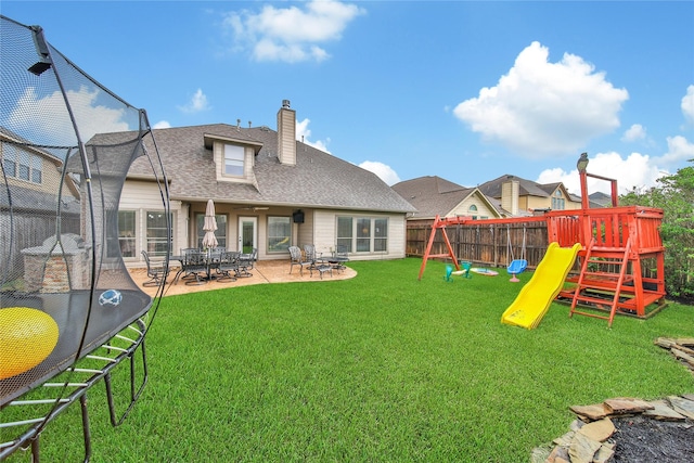 14314 Prosper Ridge Dr, Cypress, TX 77429 - back of house featuring a playground, a patio, a chimney, and a shingled roof