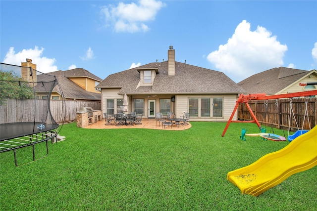 14314 Prosper Ridge Dr, Cypress, TX 77429 - rear view of property with a playground, a fenced backyard, a patio area, a chimney, and a shingled roof