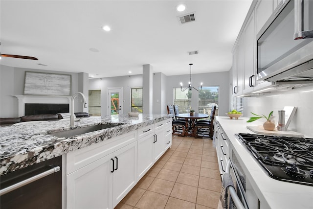 14314 Prosper Ridge Dr, Cypress, TX 77429 - kitchen featuring appliances with stainless steel finishes, a ceiling fan, light tile patterned floors, white cabinetry, and recessed lighting