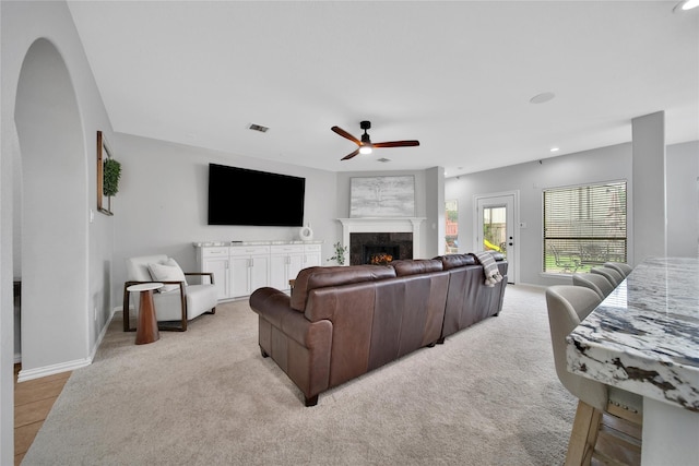 14314 Prosper Ridge Dr, Cypress, TX 77429 - carpeted living area with ceiling fan, a premium fireplace, recessed lighting, and arched walkways