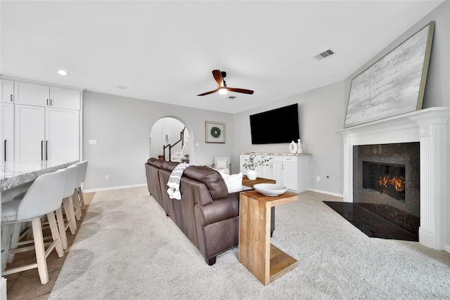 14314 Prosper Ridge Dr, Cypress, TX 77429 - living area featuring arched walkways, light carpet, a ceiling fan, a fireplace, and recessed lighting