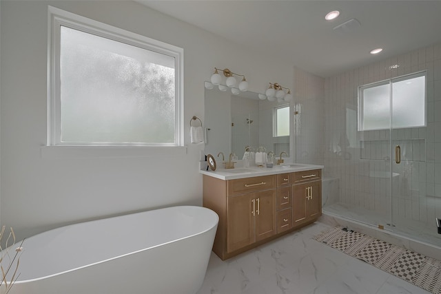 776 Mansfield St, Houston, TX 77091 - bathroom with healthy amount of natural light, a freestanding tub, double vanity, a shower stall, and recessed lighting