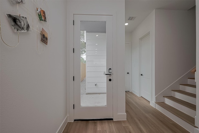 776 Mansfield St, Houston, TX 77091 - doorway to outside featuring wood finished floors, stairs, and recessed lighting