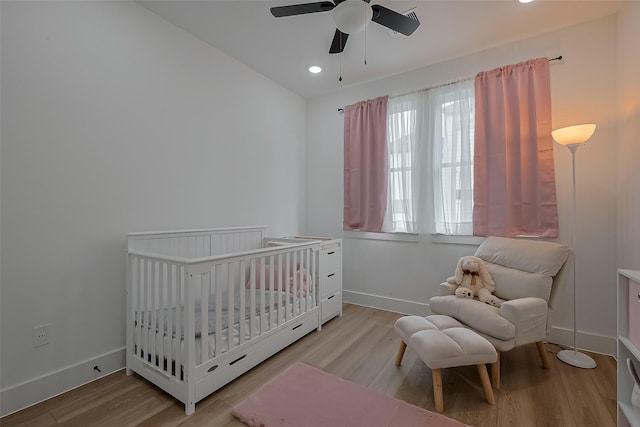 776 Mansfield St, Houston, TX 77091 - bedroom featuring light wood finished floors, a crib, ceiling fan, and recessed lighting