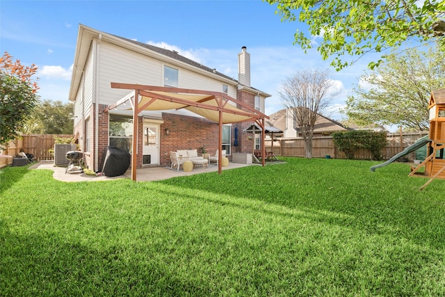 18914 Woodglen Shadows Dr, Humble, TX 77346 - back of property featuring brick siding, a patio, a fenced backyard, and a playground