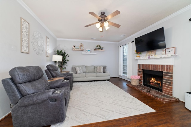 18914 Woodglen Shadows Dr, Humble, TX 77346 - living room featuring ornamental molding, ceiling fan, wood finished floors, and a brick fireplace