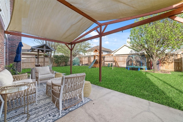 18914 Woodglen Shadows Dr, Humble, TX 77346 - fenced backyard with a patio, a playground, and an outdoor living space