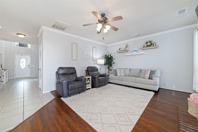 18914 Woodglen Shadows Dr, Humble, TX 77346 - living room featuring ceiling fan, ornamental molding, and wood finished floors