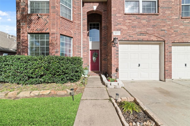 18914 Woodglen Shadows Dr, Humble, TX 77346 - view of exterior entry featuring driveway, brick siding, and an attached garage