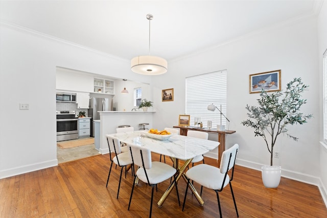 2909 Arbor St, Houston, TX 77004 - dining space featuring ornamental molding and light wood-type flooring