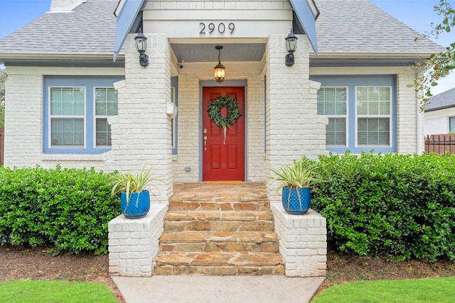 2909 Arbor St, Houston, TX 77004 - entrance to property featuring a shingled roof, brick siding, and a chimney