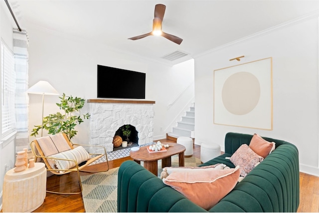 2909 Arbor St, Houston, TX 77004 - living area featuring wood finished floors, crown molding, a ceiling fan, a fireplace, and stairs
