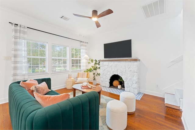 2909 Arbor St, Houston, TX 77004 - living area with wood finished floors, ornamental molding, a stone fireplace, and ceiling fan