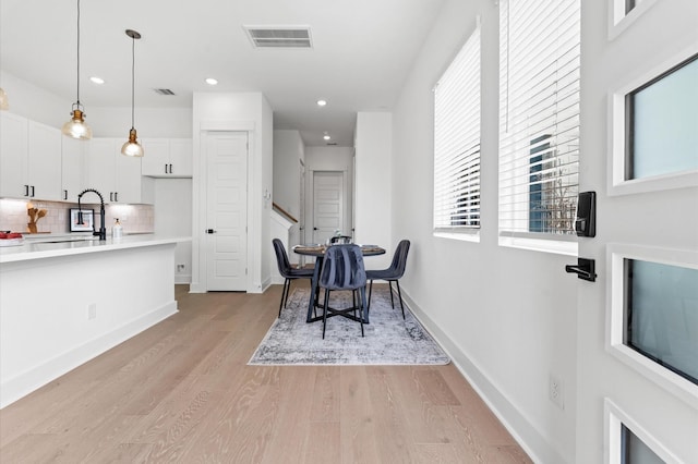2213 Springwood Vista Ln, Houston, TX 77055 - dining space with light wood-type flooring, stairs, and recessed lighting