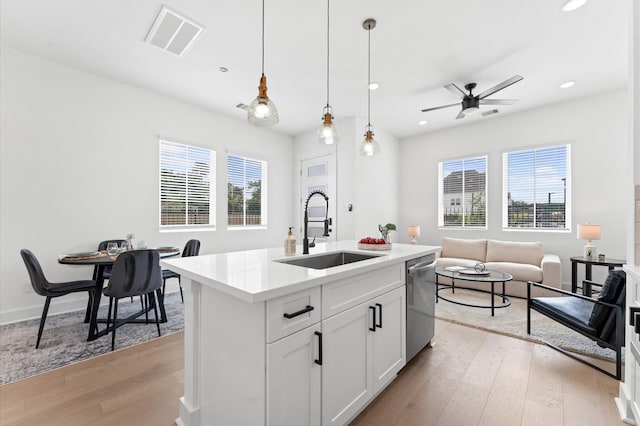 2213 Springwood Vista Ln, Houston, TX 77055 - kitchen featuring stainless steel dishwasher, light wood-style floors, open floor plan, decorative light fixtures, and recessed lighting