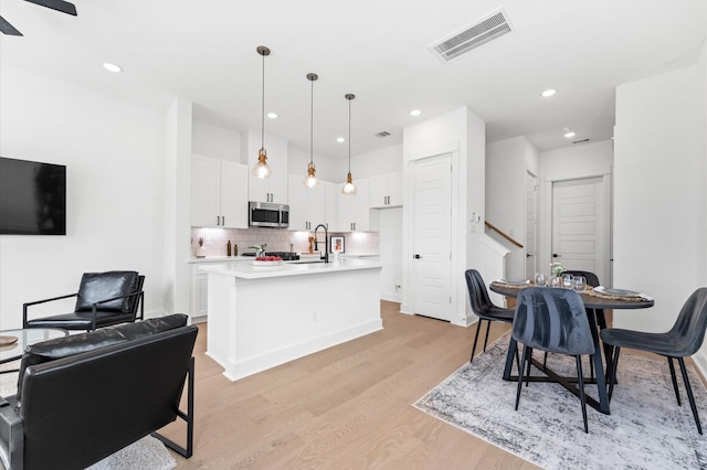 2213 Springwood Vista Ln, Houston, TX 77055 - dining space featuring light wood-type flooring, recessed lighting, and a ceiling fan