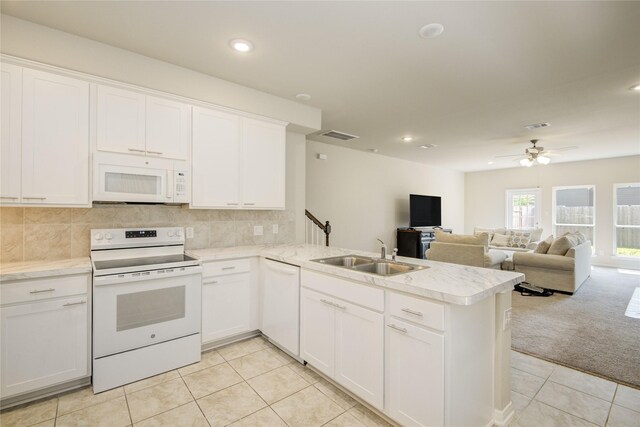 527 Dr Martin Luther King Jr Dr Unit D, La Porte, TX 77571 - kitchen featuring white appliances, light tile patterned floors, a peninsula, light countertops, and recessed lighting
