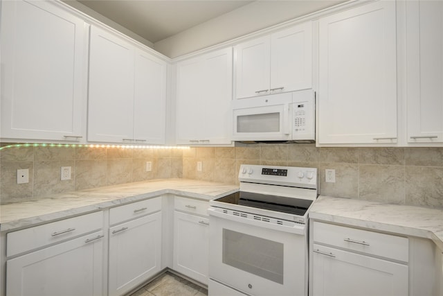 527 Dr Martin Luther King Jr Dr Unit D, La Porte, TX 77571 - kitchen featuring white appliances, white cabinetry, and backsplash