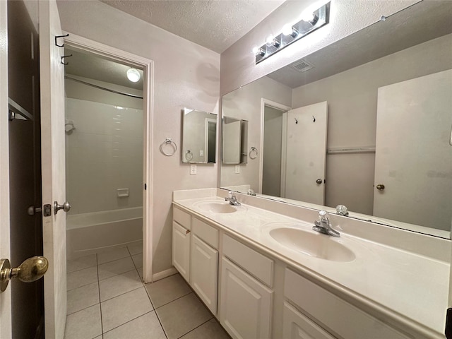 12807 Stratford Heights Dr, Sugar Land, TX 77498 - full bathroom featuring double vanity, tile patterned flooring, a textured ceiling, and  shower combination