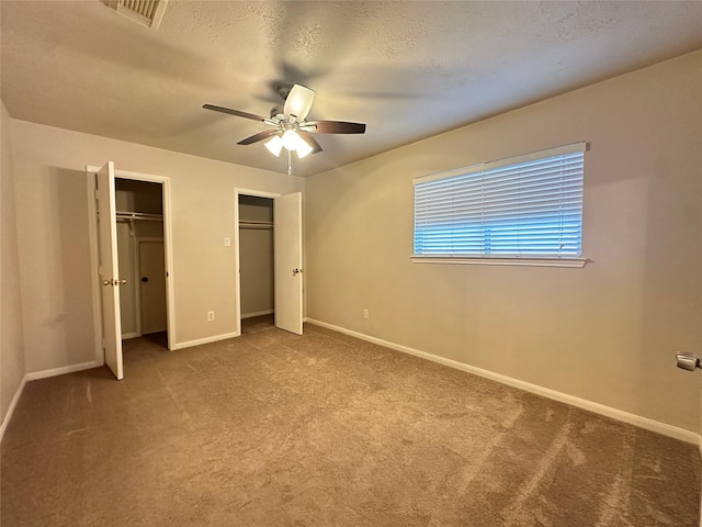 12807 Stratford Heights Dr, Sugar Land, TX 77498 - unfurnished bedroom featuring multiple closets, carpet flooring, and ceiling fan