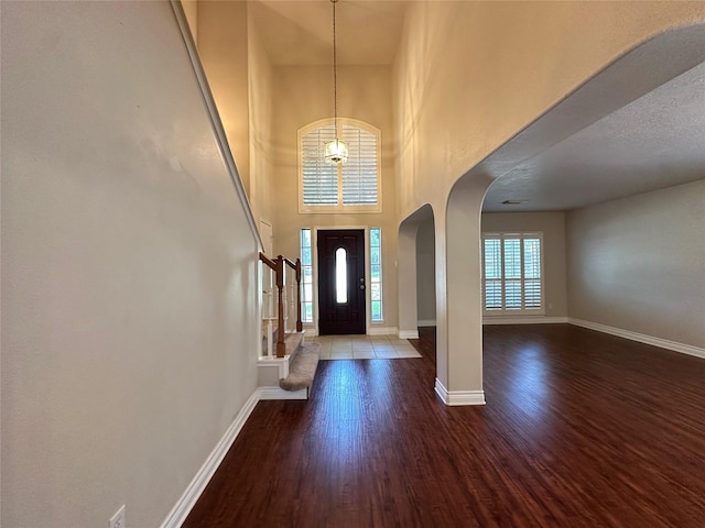 12807 Stratford Heights Dr, Sugar Land, TX 77498 - entryway with arched walkways, wood finished floors, a chandelier, and a towering ceiling