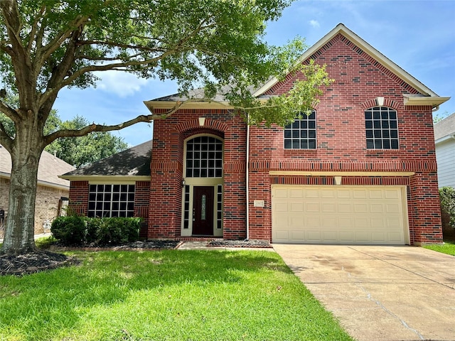 12807 Stratford Heights Dr, Sugar Land, TX 77498 - traditional home featuring concrete driveway, brick siding, a front yard, and a garage