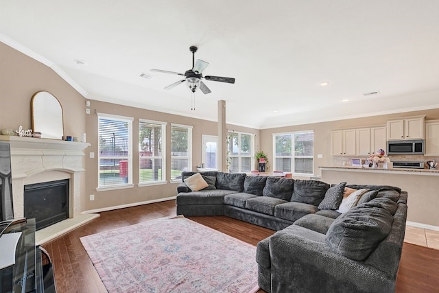 19443 Alton Springs Dr, Cypress, TX 77433 - living area with crown molding, a fireplace with raised hearth, dark wood finished floors, ceiling fan, and recessed lighting