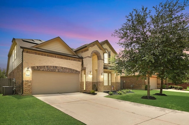 19443 Alton Springs Dr, Cypress, TX 77433 - view of front of property featuring brick siding, a garage, concrete driveway, solar panels, and a front yard