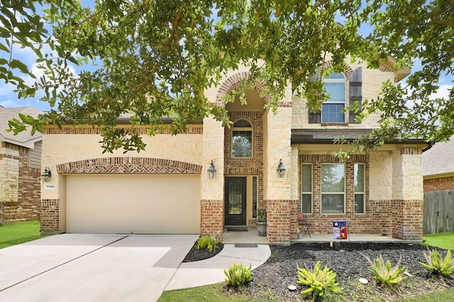 19443 Alton Springs Dr, Cypress, TX 77433 - view of front facade featuring concrete driveway, a garage, and stone siding
