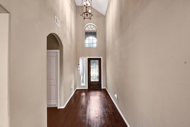 19443 Alton Springs Dr, Cypress, TX 77433 - entrance foyer with arched walkways, high vaulted ceiling, dark wood-type flooring, and a chandelier