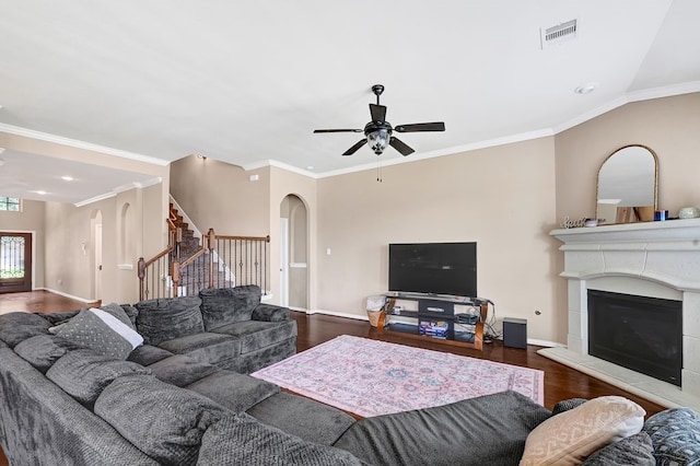 19443 Alton Springs Dr, Cypress, TX 77433 - living area featuring stairs, wood finished floors, a glass covered fireplace, ceiling fan, and arched walkways