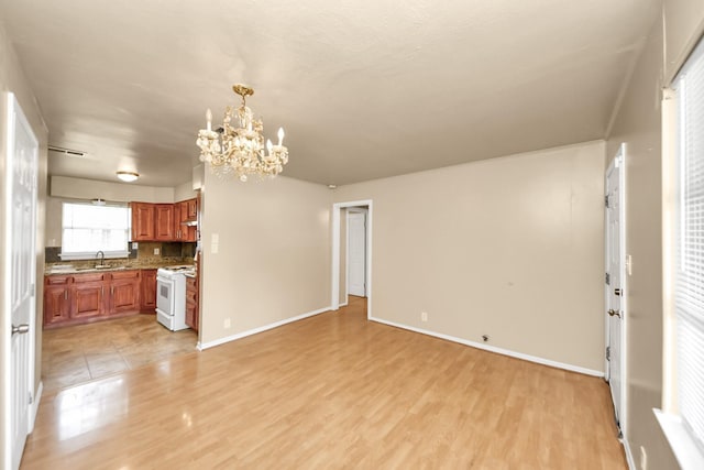 9417 Fairland Dr, Houston, TX 77051 - unfurnished living room featuring a chandelier and light wood-style flooring