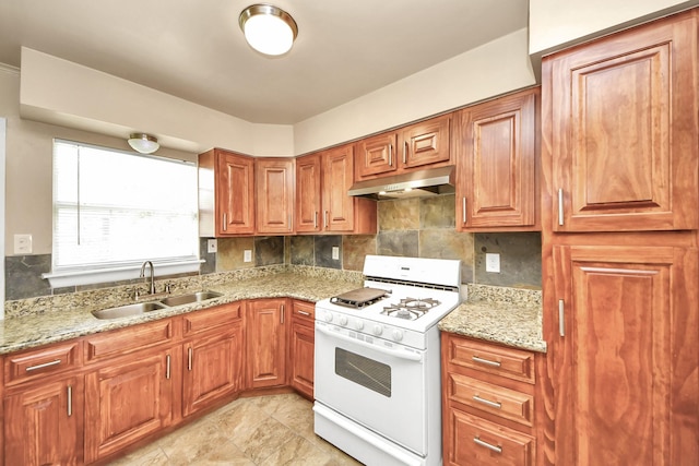 9417 Fairland Dr, Houston, TX 77051 - kitchen with white range with gas cooktop, under cabinet range hood, and tasteful backsplash