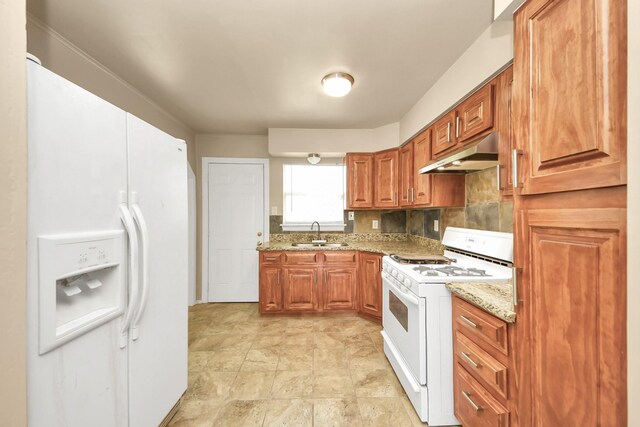 9417 Fairland Dr, Houston, TX 77051 - kitchen featuring white appliances, under cabinet range hood, brown cabinetry, and light stone countertops