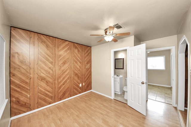 9417 Fairland Dr, Houston, TX 77051 - unfurnished bedroom featuring connected bathroom, light wood-type flooring, and a ceiling fan